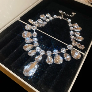 Macro shot of silver crystal necklace with pear-cut gemstones in premium gift box
