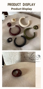 Detailed view of glossy oval resin rings in cream, burgundy, green and black finishes