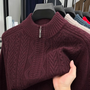 Detail of burgundy cable knit sweater showing thick fabric texture and half-zip collar