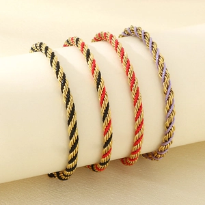Stack of 18K gold plated stainless steel twisted rope bracelets with colorful threads