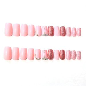 Pink French style press-on nails set with glitter and rhinestone accents on medium square tips