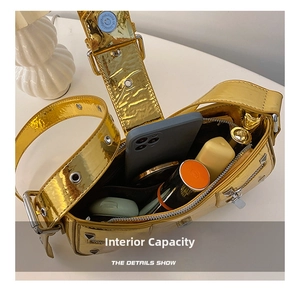 Internal capacity of the gold metallic shoulder bag showing phone and cosmetics