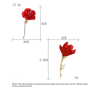 Detail view of red rose and tulip brooches with dimensions and pearls on white background