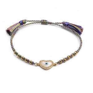 Detail of hand-woven colorful rope bracelet with heart evil eye charm and gold beads