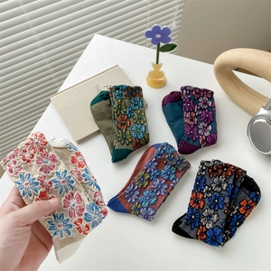 Detailed close-up of floral embroidery on 5 pairs of vintage mid-calf cotton socks