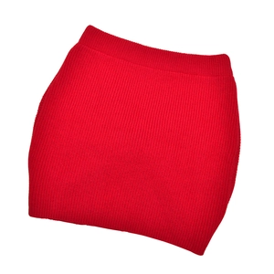 Detailed view of red vertical ribbed knit texture on a slim-fit bodycon skirt