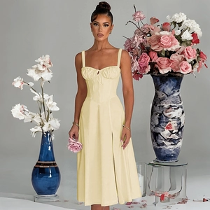 Detail of slim fit yellow summer dress with side slit and waist tie-up design
