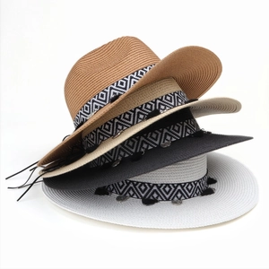 Detail showing colorful straw hats with tassel charms and geometric patterned ribbons