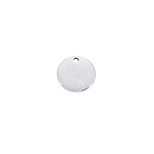 Close-up of circular stainless steel pendant with floral engraving and mirror finish