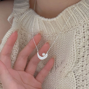 Elegant 925 sterling silver crescent moon pearl necklace worn on a cream knit sweater
