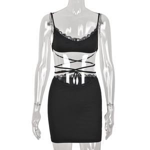 Sexy black two-piece beach set featuring lace-trim crop top and lace-up bodycon skirt