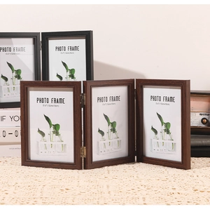 Triple folding 5x7 inch dark brown wood grain photo frame on lace tablecloth detail