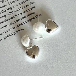Elegant 925 sterling silver heart pearl drop earrings on a vintage book background