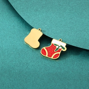 Detailed close-up of red enamel Christmas stocking charms for DIY jewelry making