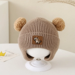 Detailed knit texture and brown cartoon dinosaur patch on baby winter earflap hat