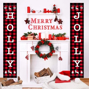 Close-up of red and black plaid Holly Jolly Christmas door banners beside fireplace