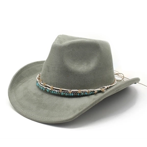 Close-up of sage green cowboy hat featuring intricate beaded bands and wide curved brim