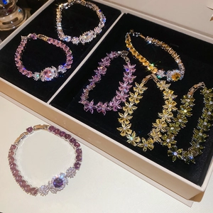 Close-up of zircon flower bracelets in diverse colors on a premium jewelry display