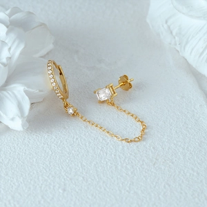 Detail of S925 sterling silver chain earrings with heart zircon and engraved hallmark