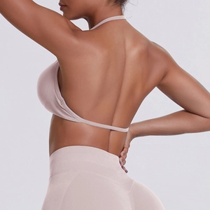 Detail of dusty pink seamless yoga set showing open back sports bra and high waist leggings