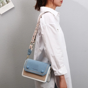 Three-color patchwork leather crossbody bag with wide embroidered strap and decor buttons