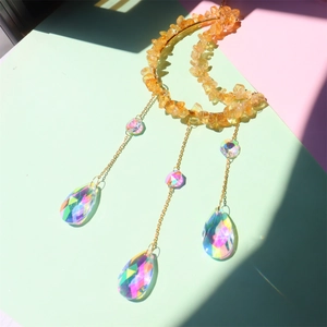 Macro detail of sun catcher with natural amethyst crystals and rainbow faceted prisms
