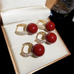 Elegant circular red zircon earrings in gold-tone resin with a vintage luxury finish