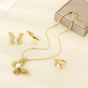 Gold hollow butterfly jewelry set with pearls on necklace, earrings and open ring