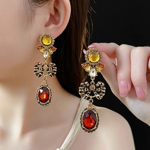 Vintage palace style earrings with red oval gemstones and golden bow accents