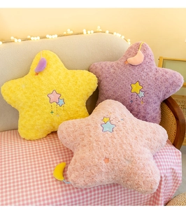 Detailed view of colorful star plush pillows with moon embroidery and soft fabric texture