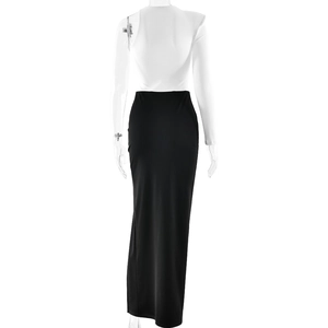 Detail of elegant two-piece black and white evening gown with one-shoulder top and high slit skirt