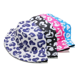 Macro display of assorted colors of fisherman hats with graffiti heart pattern prints