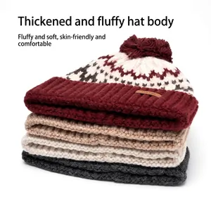 Chunky knit beanies with pom-poms in burgundy, beige, and grey colors stacked vertically
