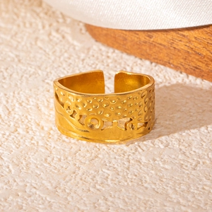 Detailed macro view of vintage hollow wavy texture on 18k gold plated stainless steel ring