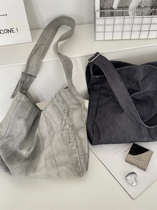 Retro tie-dye canvas tote bags in light grey and dark indigo blue on display
