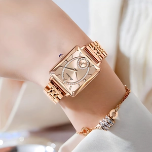 Close-up of elegant rose gold rectangular quartz watch with diamond accents on a wrist