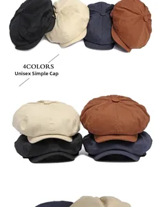 Detail view of cotton newsboy caps in black, beige, navy, and rust red colors