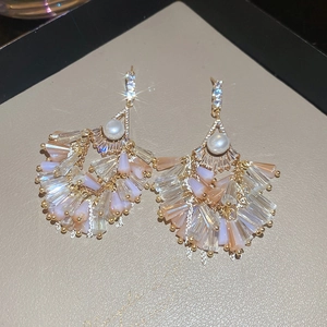 Close-up of tassel earrings with pearls and champagne crystals in vintage court style