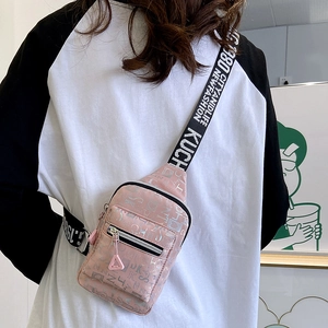Pink printed crossbody chest bag with adjustable wide strap shown in a lifestyle setting