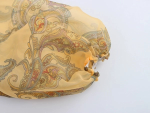 Detailed close-up of elastic lantern sleeve on organza top with paisley floral pattern