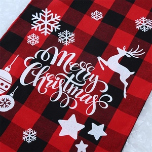Detail of red and black buffalo plaid Christmas runner with white Merry Christmas print