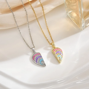 Close-up of heart-shaped magnetic puzzle necklaces with rainbow enamel and zircons