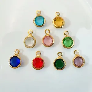 Set of nine colorful round faceted glass charms with gold plated copper borders for DIY jewelry