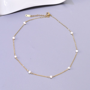 Detail of 18K gold chain necklace with freshwater pearls and adjustable lobster clasp
