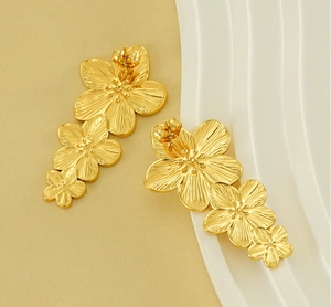 Detailed view of gold plated titanium steel drop earrings with triple flower design