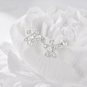 Macro shot of S925 sterling silver flower stud earrings with sparkling zircon stones