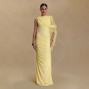 Elegant pale yellow bodycon dress with ruching details and a mesh shoulder cape