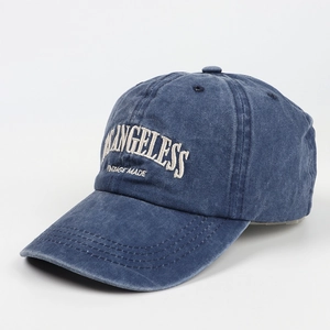 Detail of vintage navy baseball cap with white embroidery and washed distressed texture