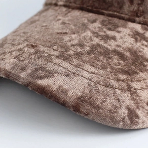 Detail of solid brown faux suede baseball cap showing fine stitching and velvet texture