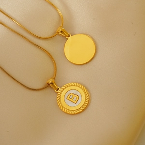 Detailed macro view of 18k gold plated round lace letter B pendant necklaces